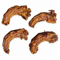 Four curved dehydrated turkey neck dog chews on white